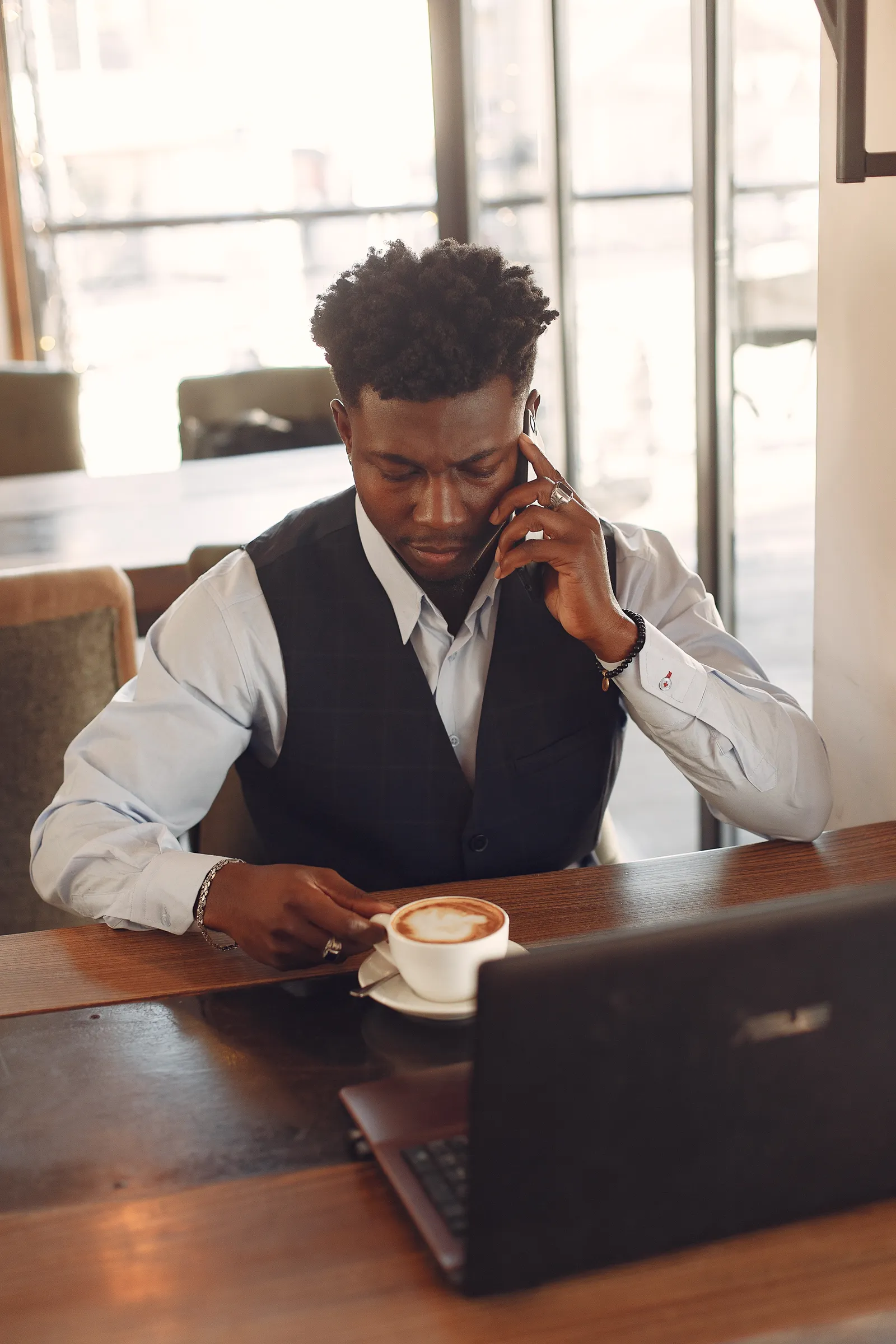 A professional reviewing information while working from a cafe
