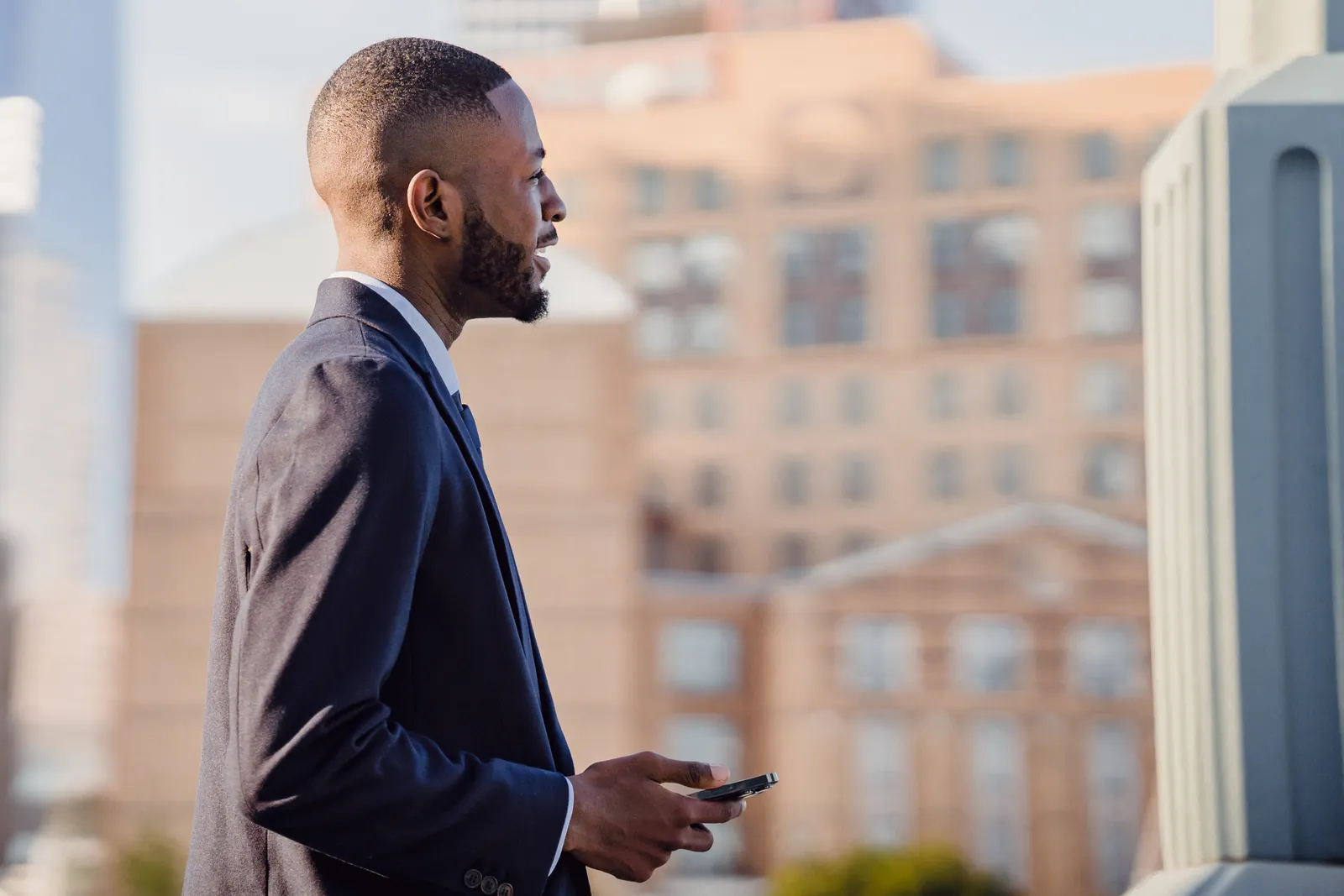 A professional using a smartphone outdoors